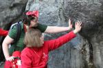 Image: Two members of HCPT Group 81 (Manchester) touch the smooth stones of the Grotto in Lourdes on the HCPT Easter 2023 pilgrimage